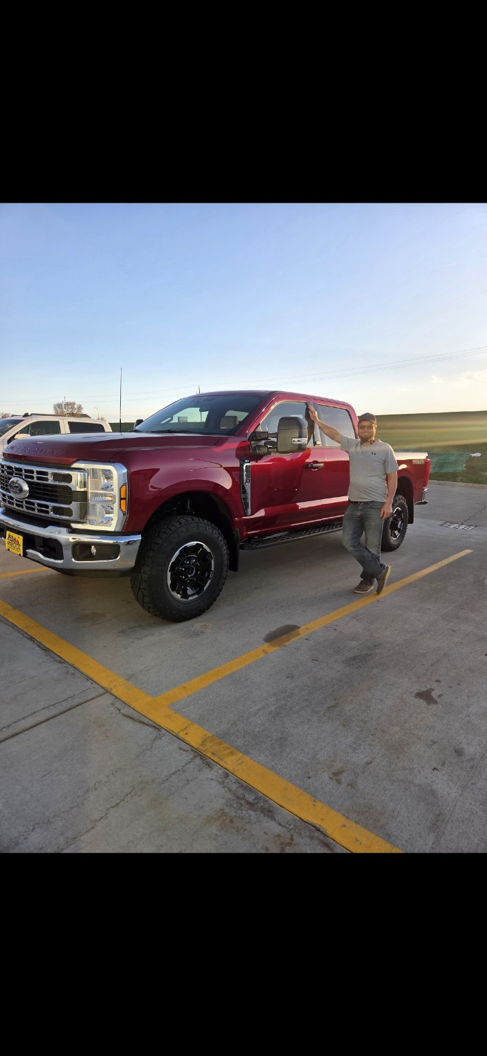 Scott Leany standing beside his red truck